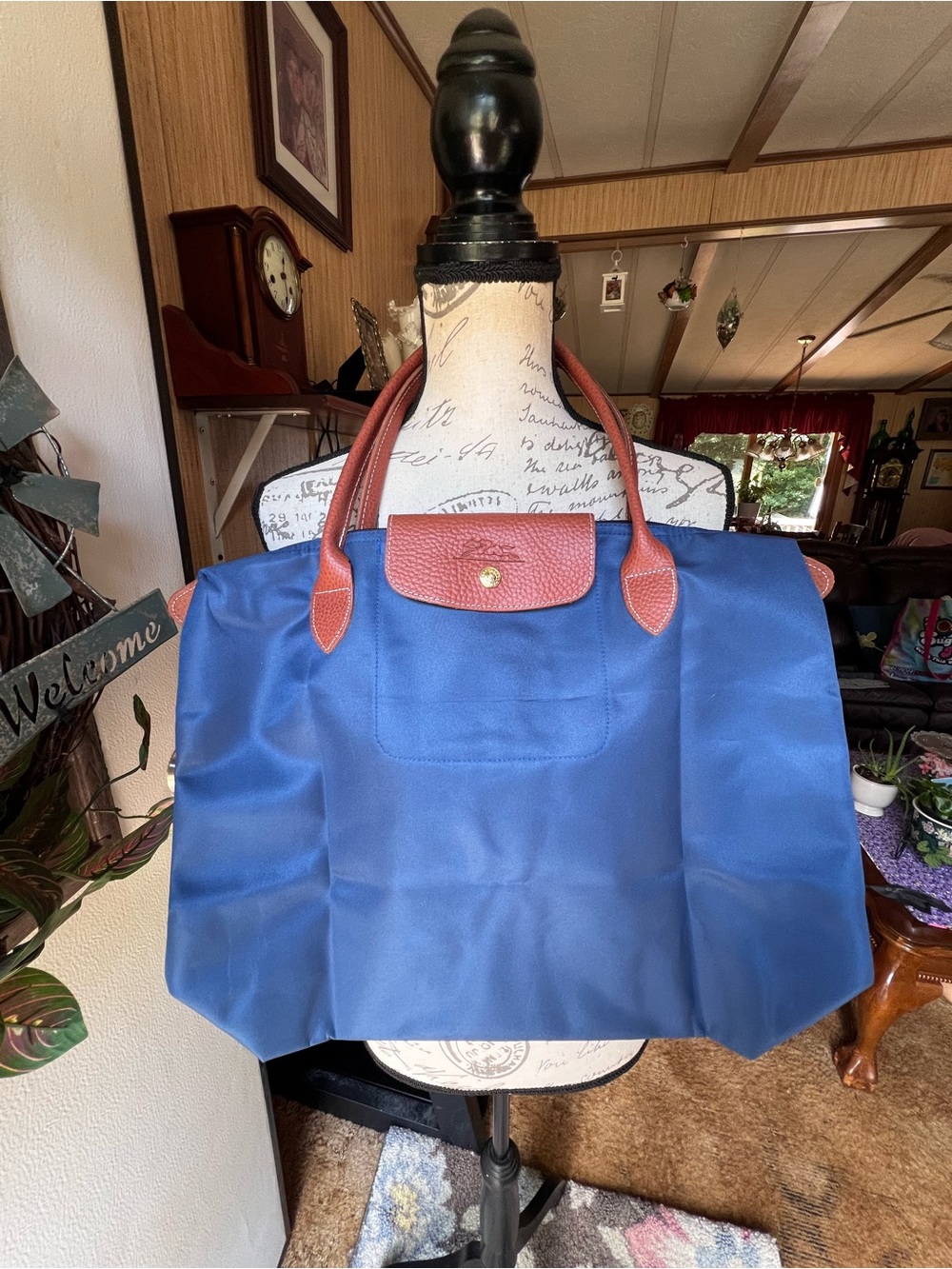 tote bag featuring brown leather handles and a matching flap blue nylon tote bag